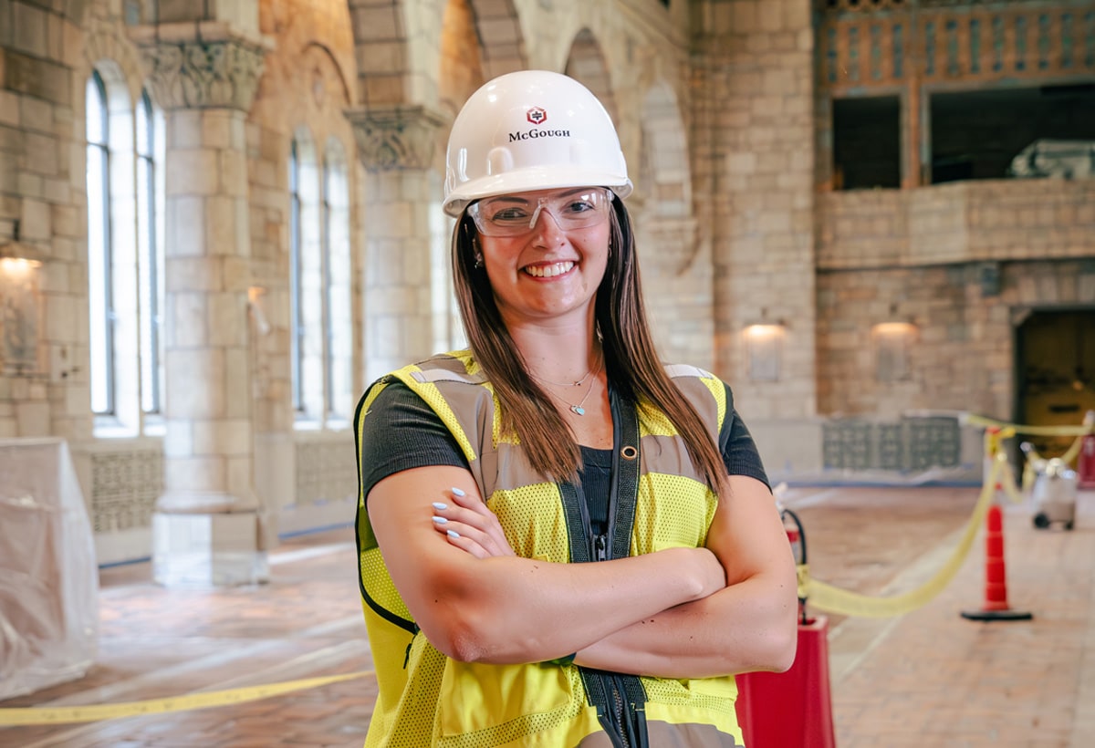 Image of McGough intern Lindsey Hays, wearing hard hat and yellow vest